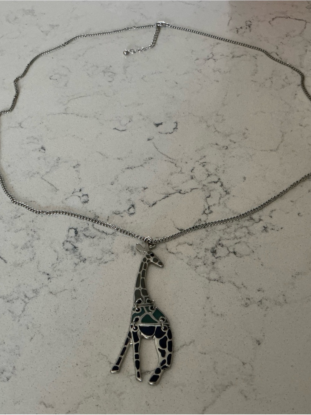 Silver-toned articulated giraffe pendant necklace with green,blue purple enamel